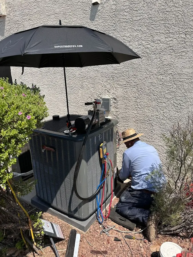 HVAC technician performing outdoor AC maintenance in Reynoldsburg